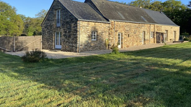 A stone farmhouse with a sloped roof, a gravel driveway, and a grassy lawn. - House 200 m2 for 11 people with heated swimming pool. (STE ANNE SUR VILAINE)