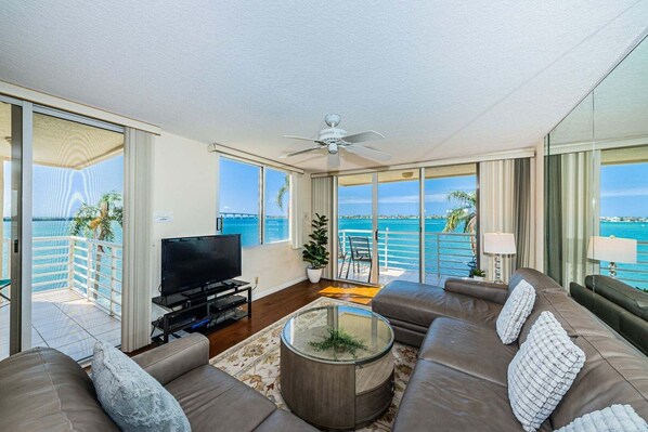 A modern living room with a television, sofa, and coffee table.