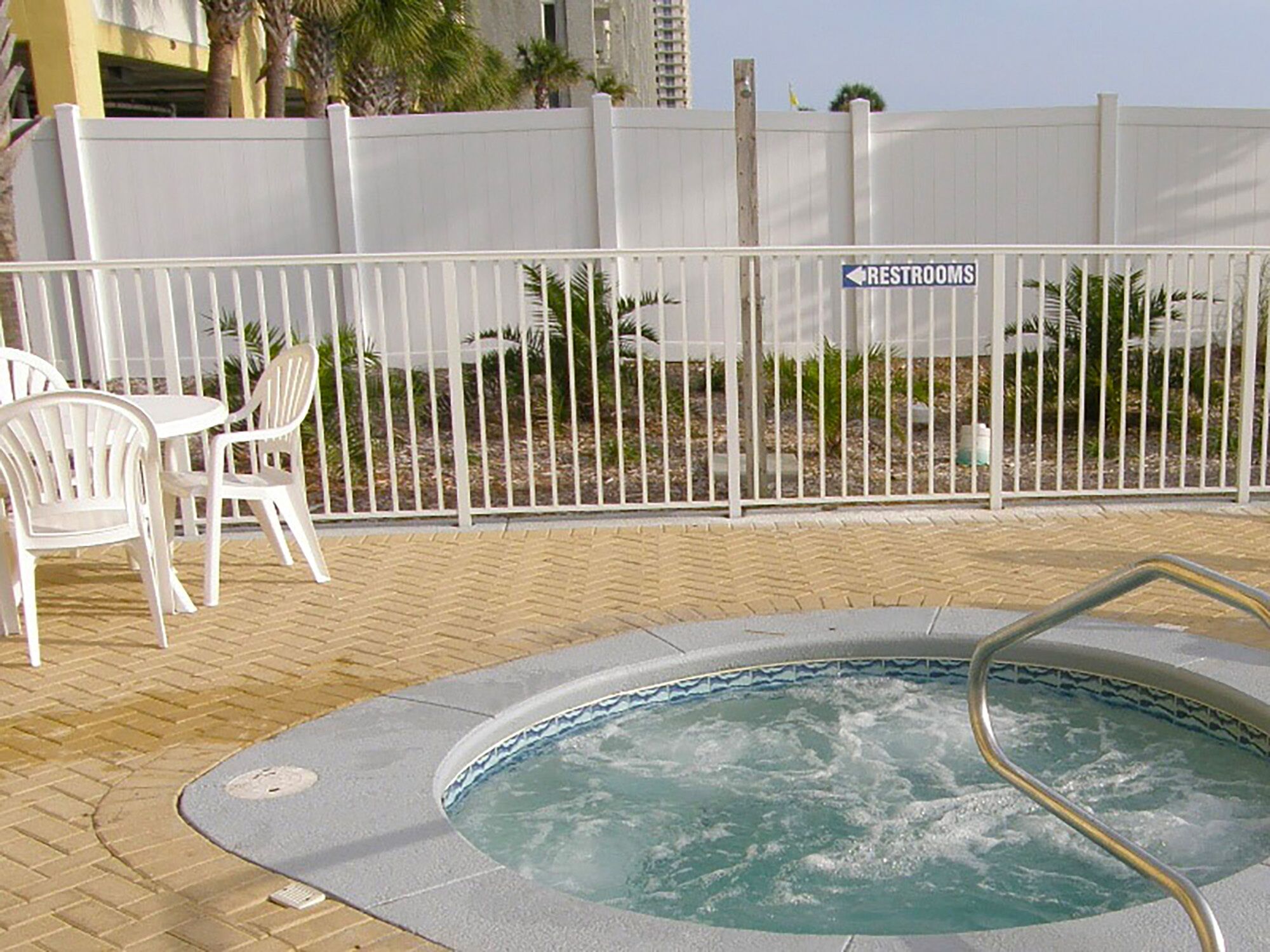A hot tub area with a sign indicating restrooms.