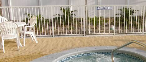 A hot tub area with a sign indicating restrooms.