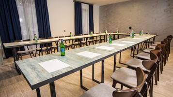 A conference room with a long table, chairs, and bottles of water.