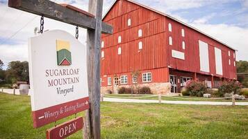 Ein rotes Bauernhaus mit einem Schild für Sugarloaf Mountain Vineyard.