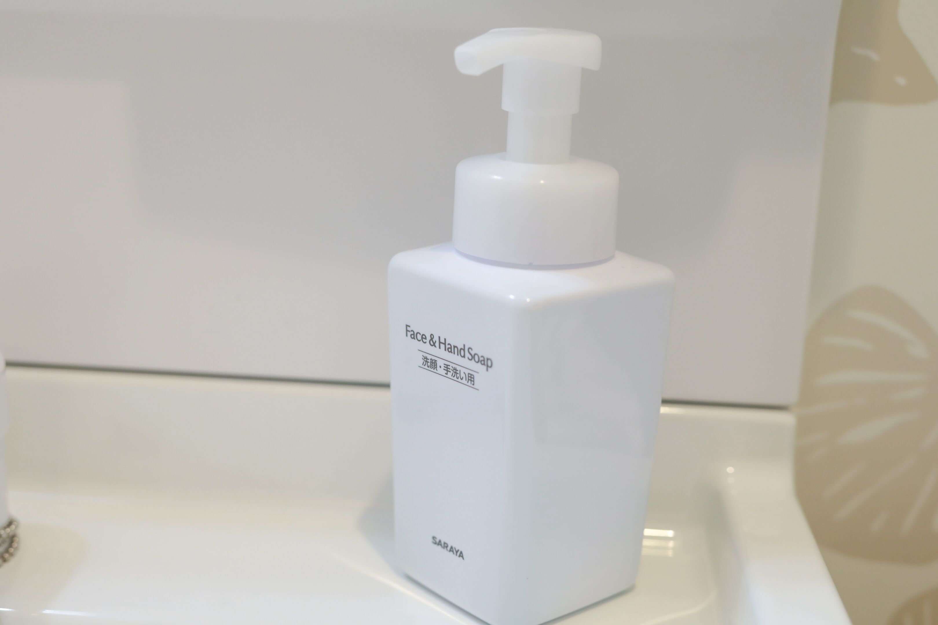A white bottle of face and hand soap with a pump dispenser, labeled 'Saray'.