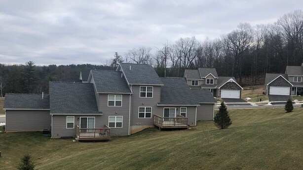 A residential area with houses featuring gabled roofs and front porches. - 12 minutes to PennState (Bellefonte)