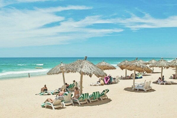 On the beach, sun loungers, beach towels