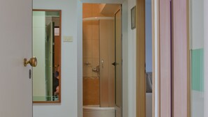 A hallway with wooden flooring, a glass shower door, and a mirror on the left wall. - Apartment near centar-view to port from apartment (Split)