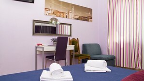 A hotel room with a bed, a desk, a chair, a sofa, a television, and a window with curtains. - Apartment near centar-view to port from apartment (Split)