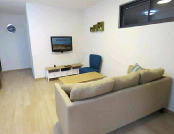 Family Apartment | Living area | 32-inch flat-screen TV with satellite channels, TV