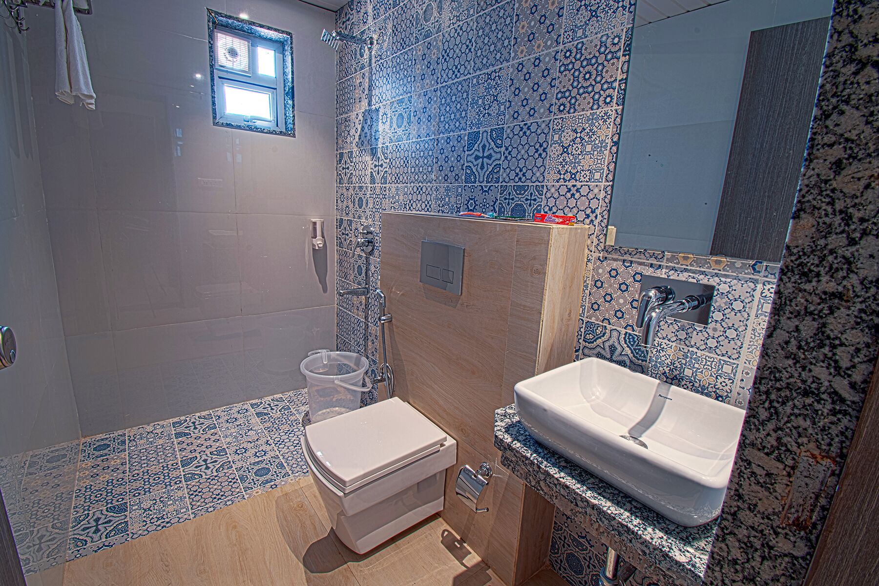A bathroom with a toilet, sink, and shower.