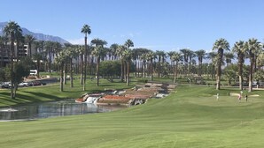 A golf course with a water hazard, palm trees, and a mountainous backdrop. - Beautiful Marriott Timeshare Unit located adjacent to JW Marriott (Palm Desert)