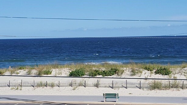 A bench by the beach with a view of the ocean. - Oceanfront 3 Bedroom 3 Full Bath Townhome With Panoramic Views Of The Ocean  (Seaside Park)