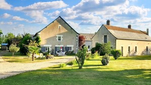A large, two-story house with a well-maintained lawn and garden. - Homerez - Studio in Thilouze (Thilouze)