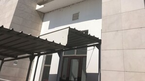 A multi-story building with a modern architectural design, featuring large windows and a flat facade. - Family Apt ❤️ underground parking❤️smoking balcony (Sector 2)