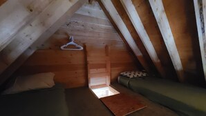 A small attic bedroom with two beds, wooden walls, and a wooden ceiling. - Bear Cabin in the Heart of Moose Country Alaska! (Ninilchik)