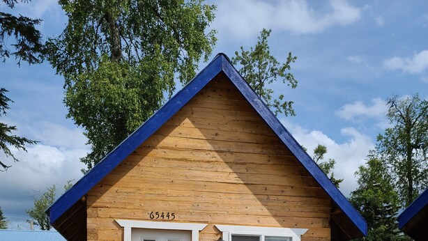 A small wooden cabin with a white door, a window, and a number '65445' above the door. - Bear Cabin in the Heart of Moose Country Alaska! (Ninilchik)