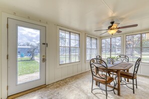 Enjoy meals in the dining area with a wooden table and metal chairs.