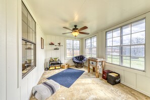 Enjoy the high ceiling and expansive views from the large windows in this inviting space.