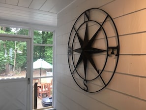 Enjoy a serene view of the garden from the large window, complemented by a unique compass wall decoration.