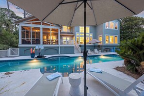 A house with a swimming pool, outdoor furniture, and a covered patio area. - Spacious Luxury Home! Private POOL and GOLF Course Views! (Kiawah Island)