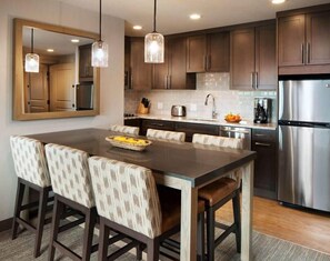 Enjoy cooking in this well-equipped kitchen with a central island and bar stools.