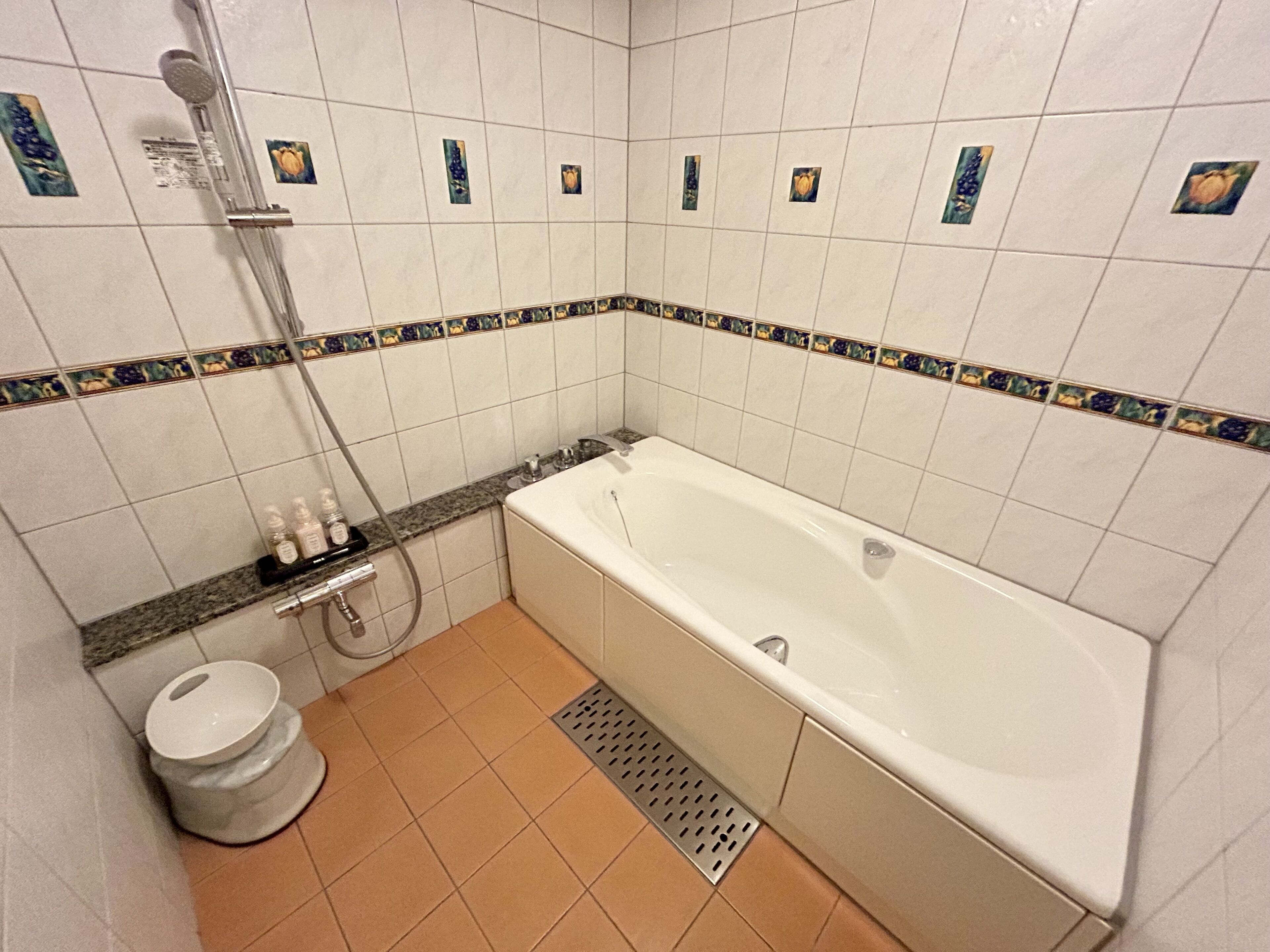 A bathroom with a bathtub, a toilet, and a shower.