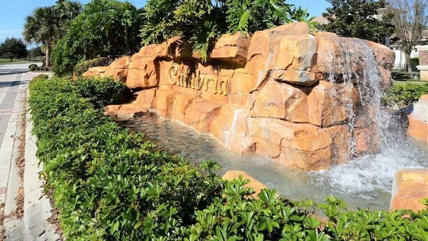 A rock formation with a waterfall and the word "Calabria" carved into it. - The Mandalori-Inn - South Pool, Conservation View! (Kissimmee)