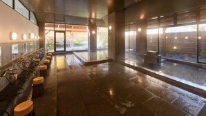A wet floor in a public restroom with multiple sinks and stools. - Bardenya Soho (Zao)