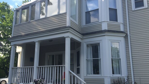 A two-story house with a covered porch and a small front yard. - Extend your rest in the Wellesley Square's best (Wellesley)