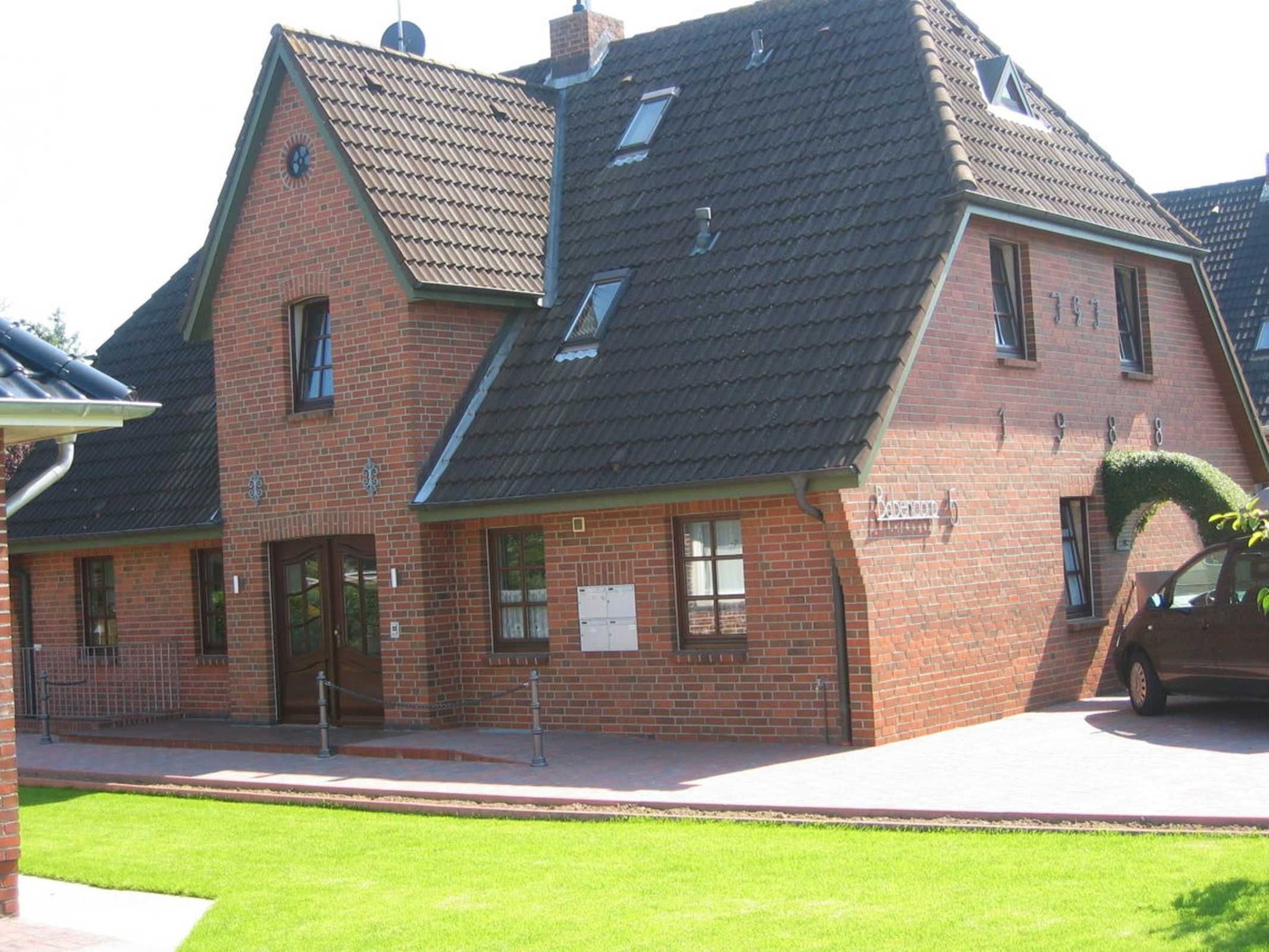 A brick building with a sloped roof, a visible entrance, and a sign indicating it is a restaurant.