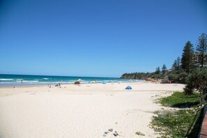 A beach with clear skies, a sandy shore, and some greenery. - The White House -  Spectacular Ocean Views, Central Coolum & WiFi  (Coolum Beach)