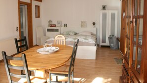 A bedroom with a bed, bedside table, and a wardrobe.