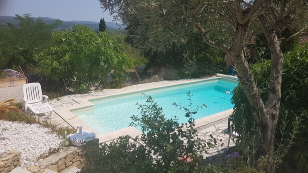 A swimming pool surrounded by trees and a basketball hoop. - Beautiful Villa in Green Provence with Swimming Pool and Bowling Alley (Tourves)