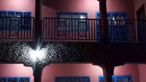 A multi-story building with balconies, decorative window grills, and a tiled ground floor. - Hakaba (Conakry)