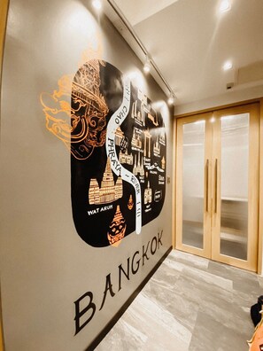 A wall with a map of Bangkok, including landmarks like Grand Palace and Wat Arun.