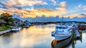 A marina with boats docked, calm water, and buildings in the background. - High Tech Hideaway: The modern beach lifestyle (Rehoboth Beach)