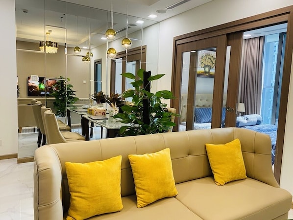 Relax in this stylish room with a sofa, dining area, and sliding glass door leading to an outdoor space.