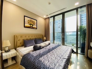 Relax in a stylish room with a large bed, bedside table, and city view.