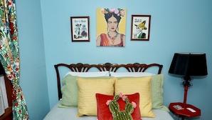 A bedroom with a bed, pillows, a cactus decoration, a lamp, and three framed artworks on the wall. - HistoricHotspot! walk to bars, resturaunts, shops. GREAT NIGHTLIFE! Pet Friendly (Jacksonville)