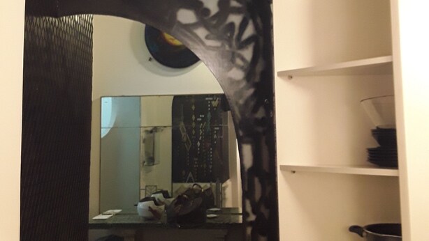 A hallway with a black decorative arch leading to a kitchen area. - Vecchia Roma House apartment  (Roma)