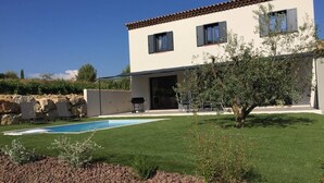 A two-story house with a swimming pool, a well-maintained lawn, and a small tree. - Villa located in the heart of Provence with private pool on 3 hectares. (Roquevaire)