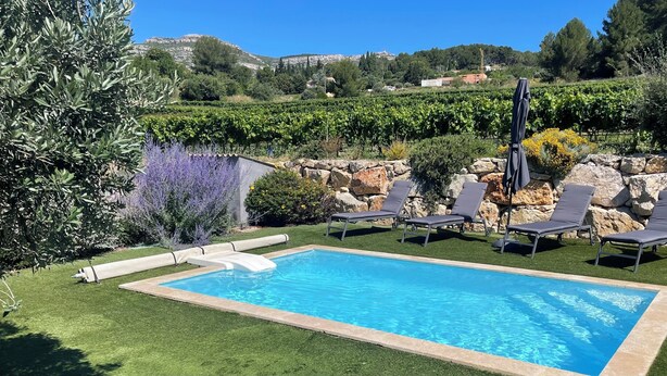 A swimming pool with lounge chairs and a view of a vineyard. - Villa located in the heart of Provence with private pool on 3 hectares. (Roquevaire)