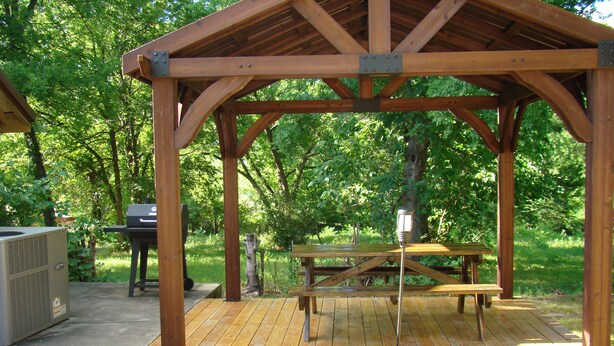 A wooden gazebo with a picnic table and grill area. - Ft Gibson Lake OK near Sequoyah State Park (Hulbert)