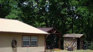 A house with a garage, a covered patio, and a stone shed. - Ft Gibson Lake OK near Sequoyah State Park (Hulbert)