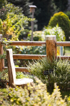 A wooden fence with a sign indicating a garden area.