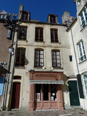 Experience the charm of a classic European building with a historic storefront and traditional architecture.