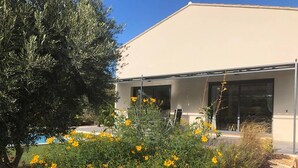 A modern building with large windows and a pool in the background. - Villa located in the heart of Provence with private pool on 3 hectares. (Roquevaire)
