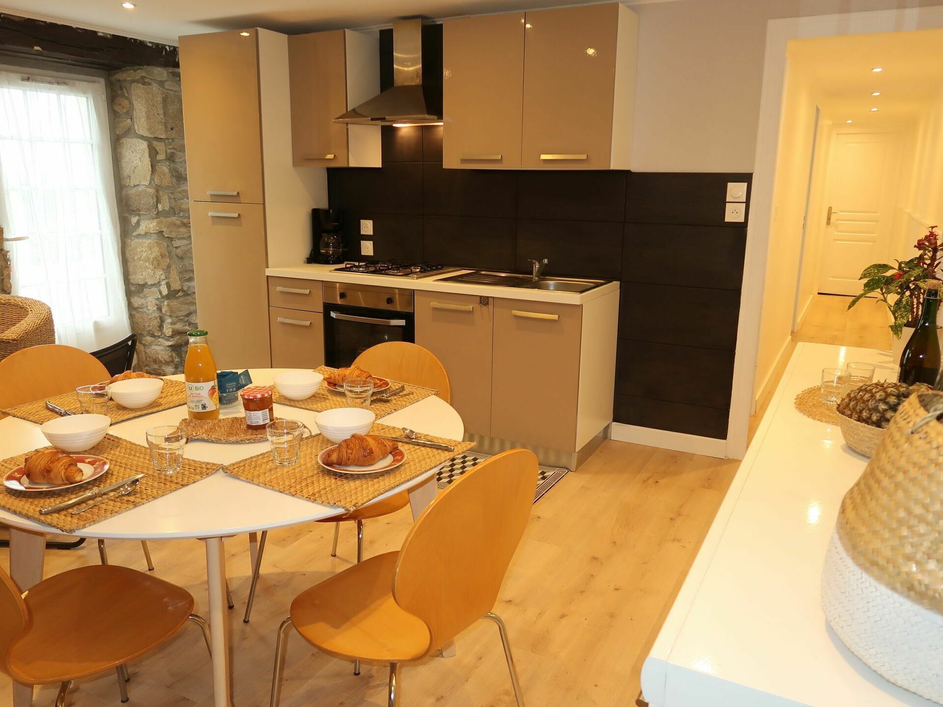 A modern kitchen with a dining area.