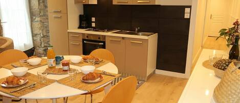 A modern kitchen with a dining area.
