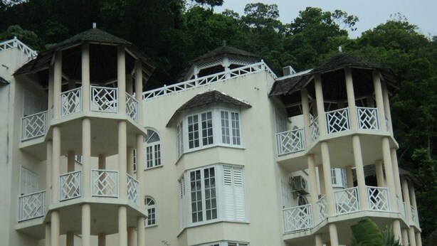 A multi-story building with balconies and large windows. - Chill on tha hill/ free wi fi <br>A/c, free wi fi, gated community  (ocho rios)