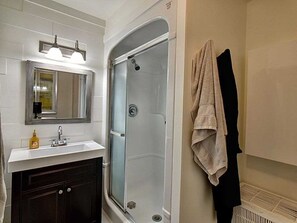 Bathtub, hair dryer, towels, toilet paper